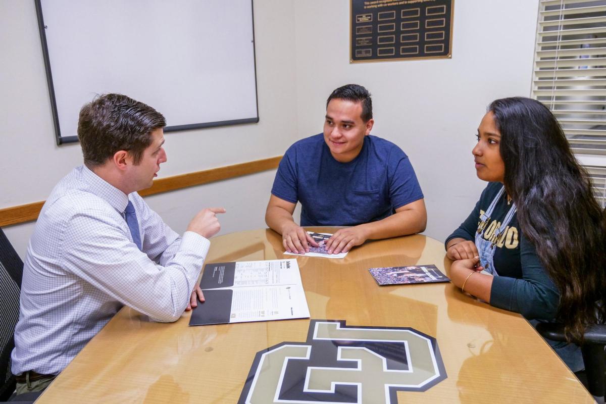 Admissions counselor meeting with students