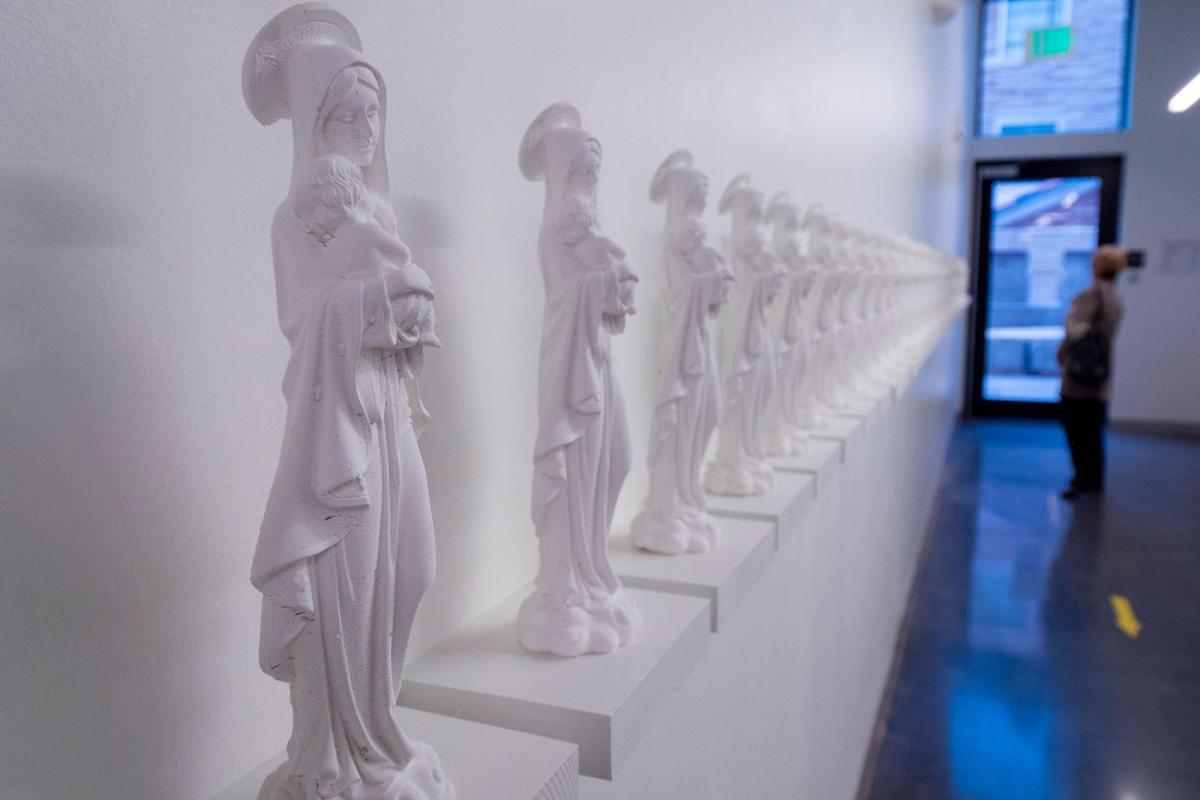 White statues in a gallery