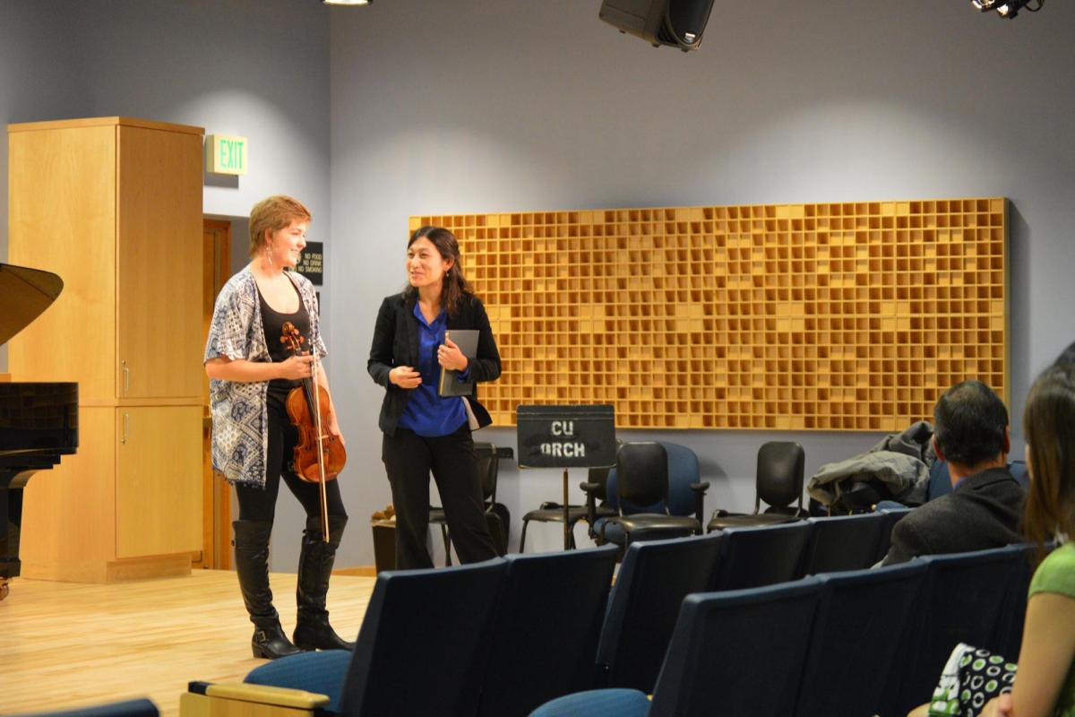 Music teacher and violin player in music class
