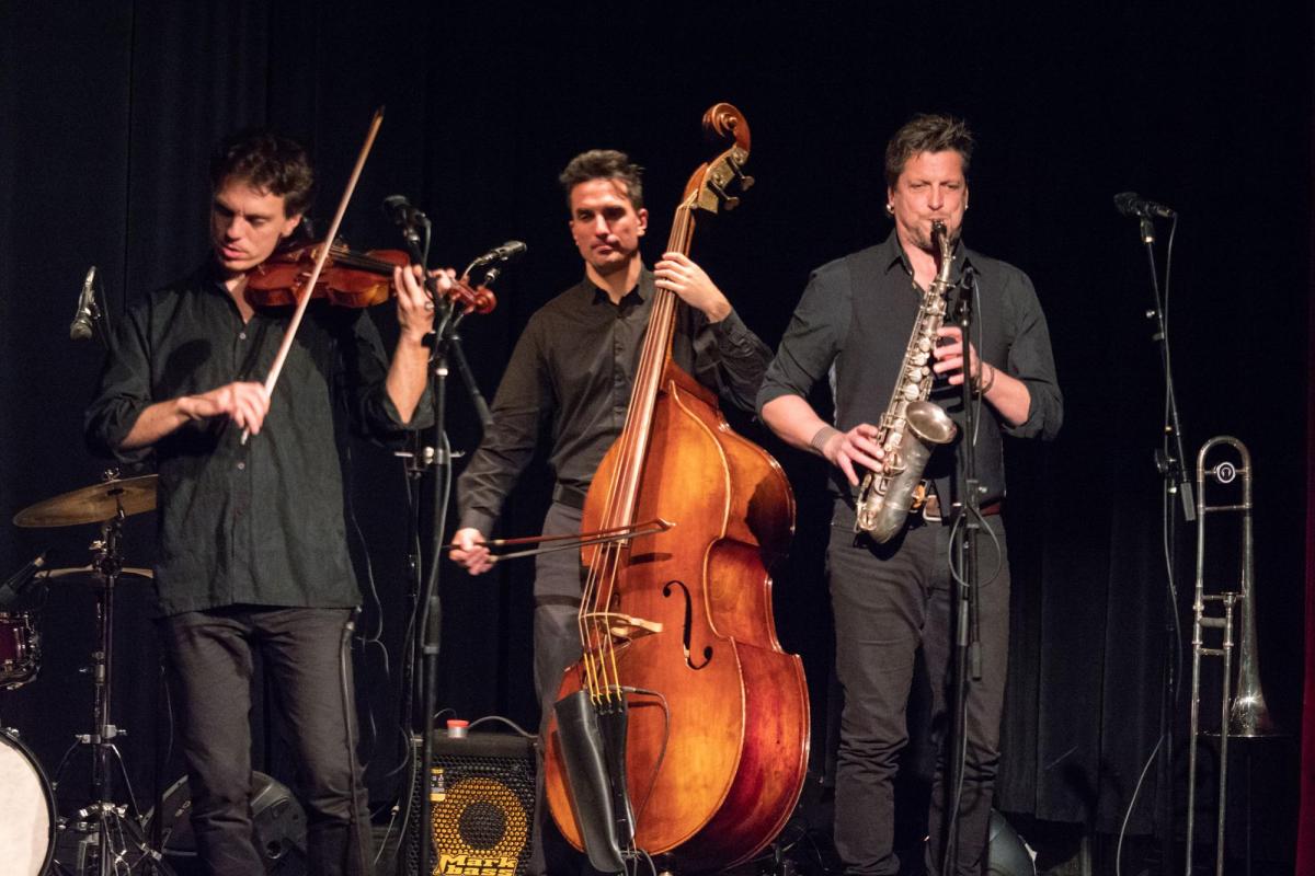 Musical performance with violin, bass and sax