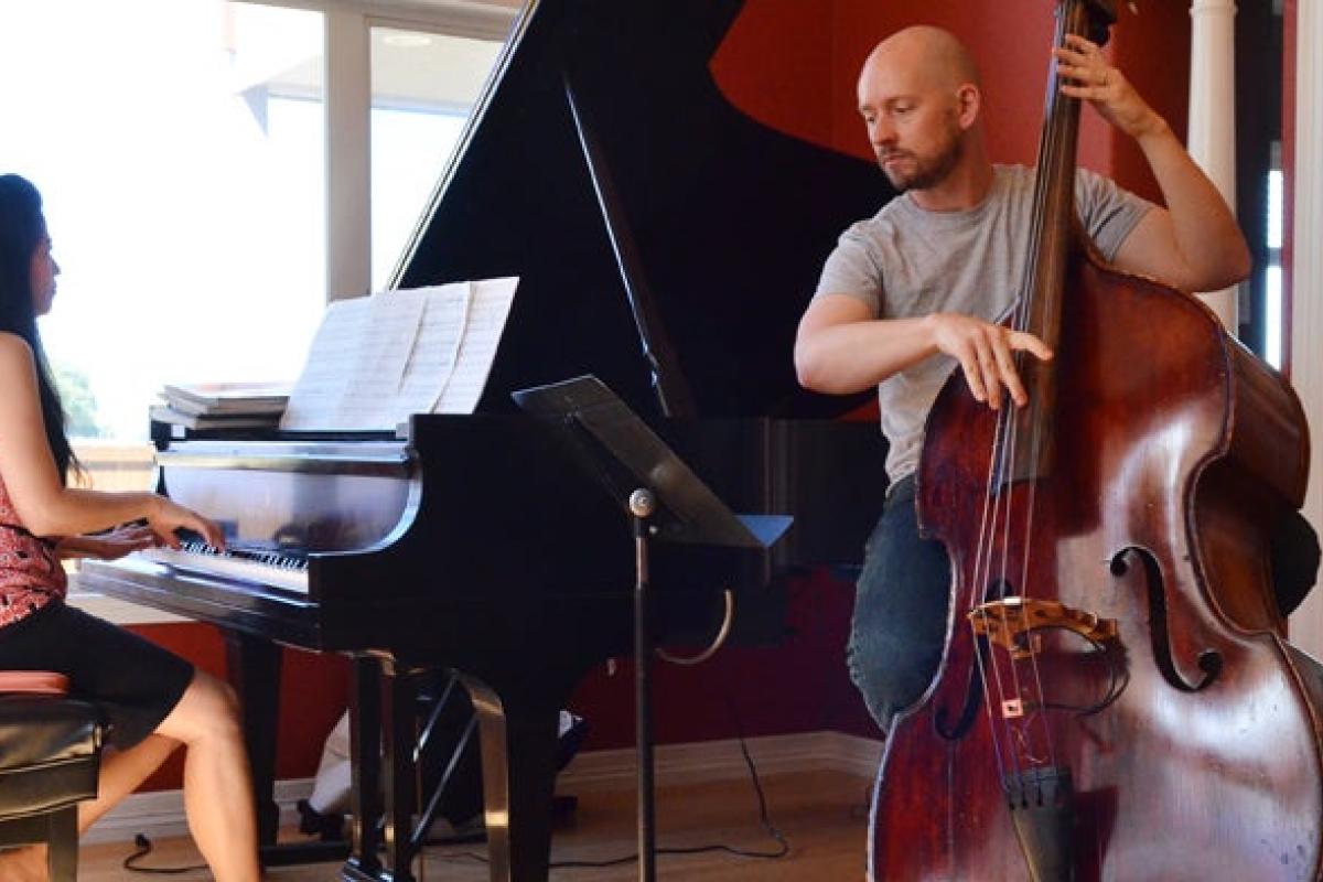 Woman playing the piano and a man playing the cello