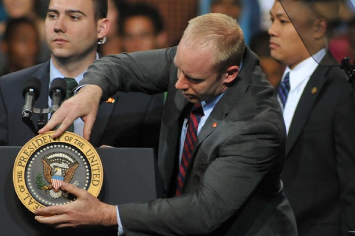 Person next to podium with American plaque