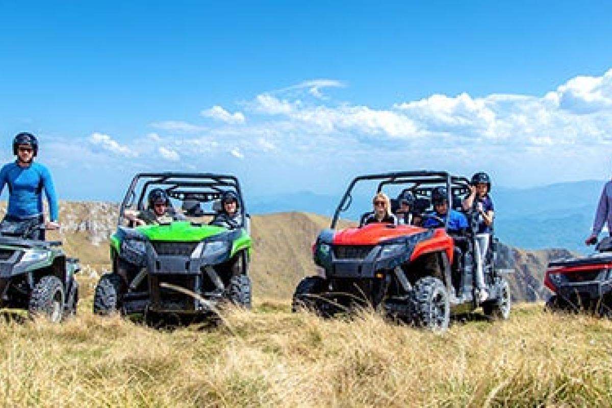 Riders on all terrain vehicles on mountaintop