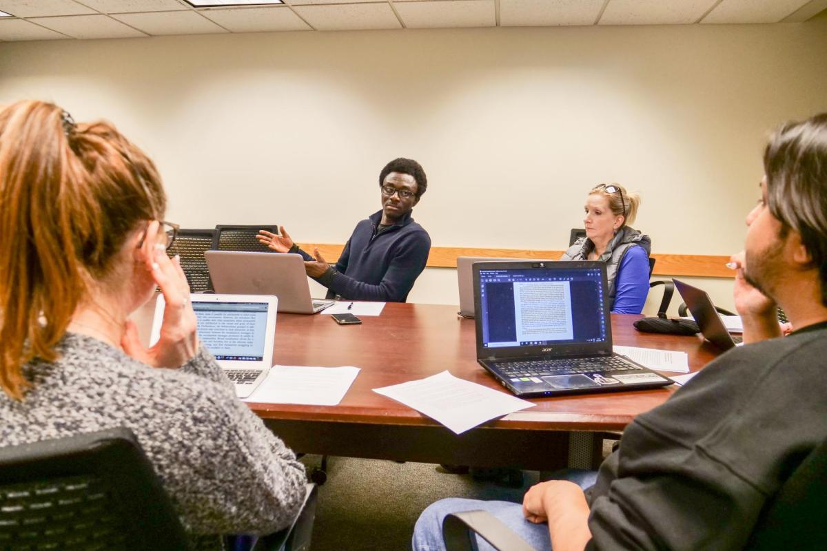 Students at table with laptops