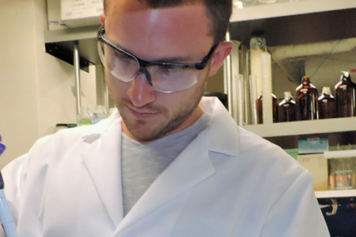 Grad student using pipet in lab