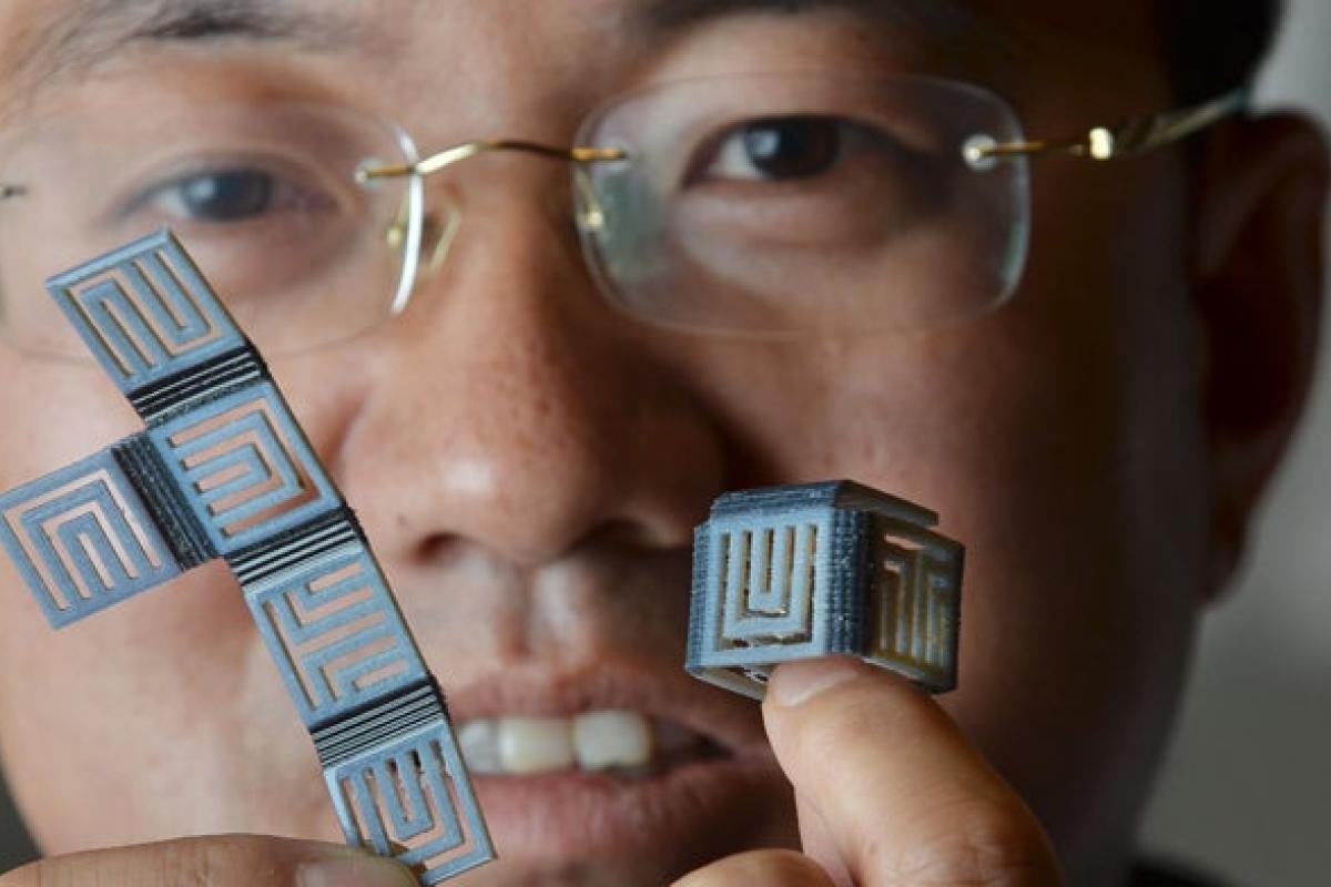 Professor holding 3D Printed cube