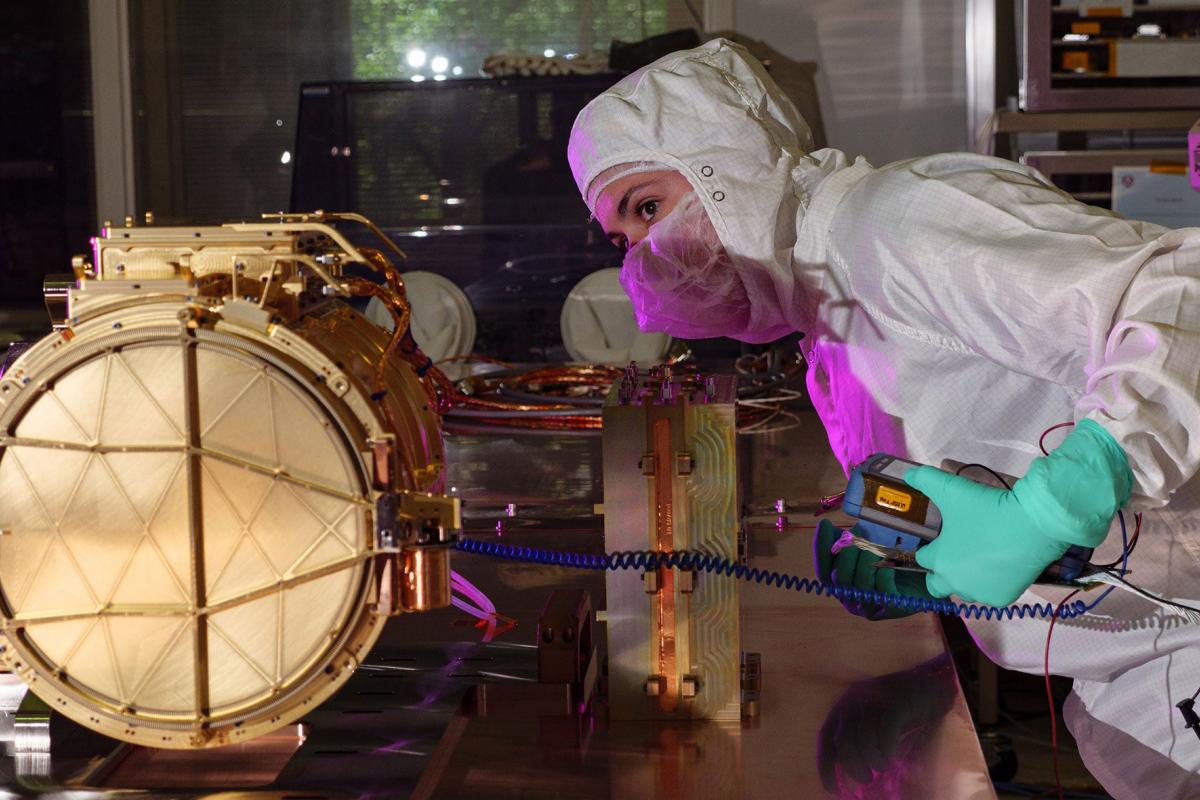 An engineer ground tests Europa Clipper’s dust analyzer