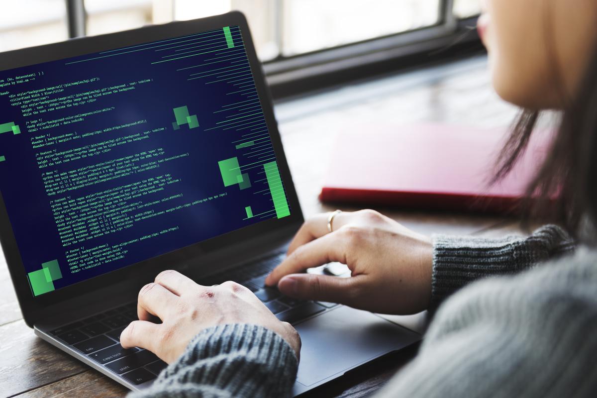 Student coding on laptop