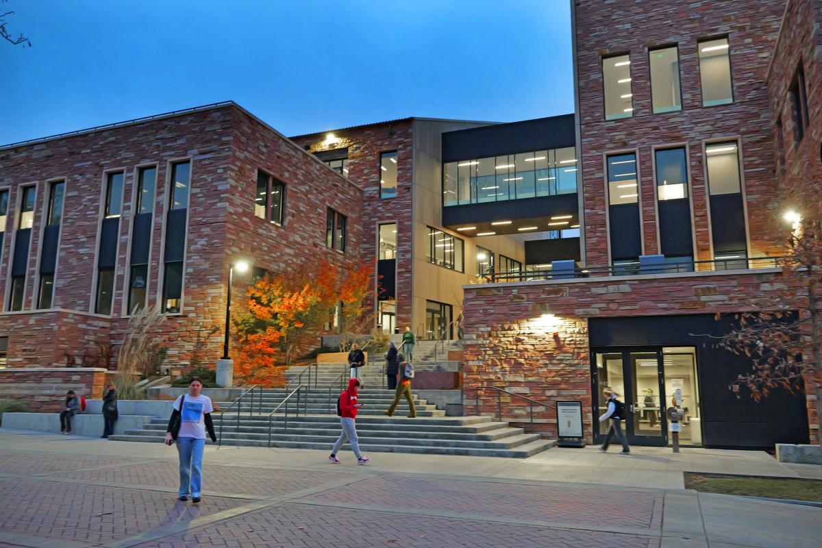 CASE Building at night with students walking
