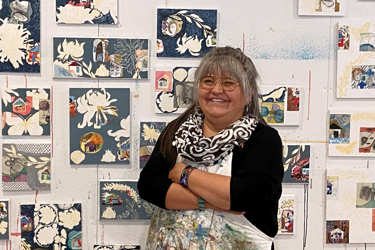 Melanie Yazzie with a collection of her prints