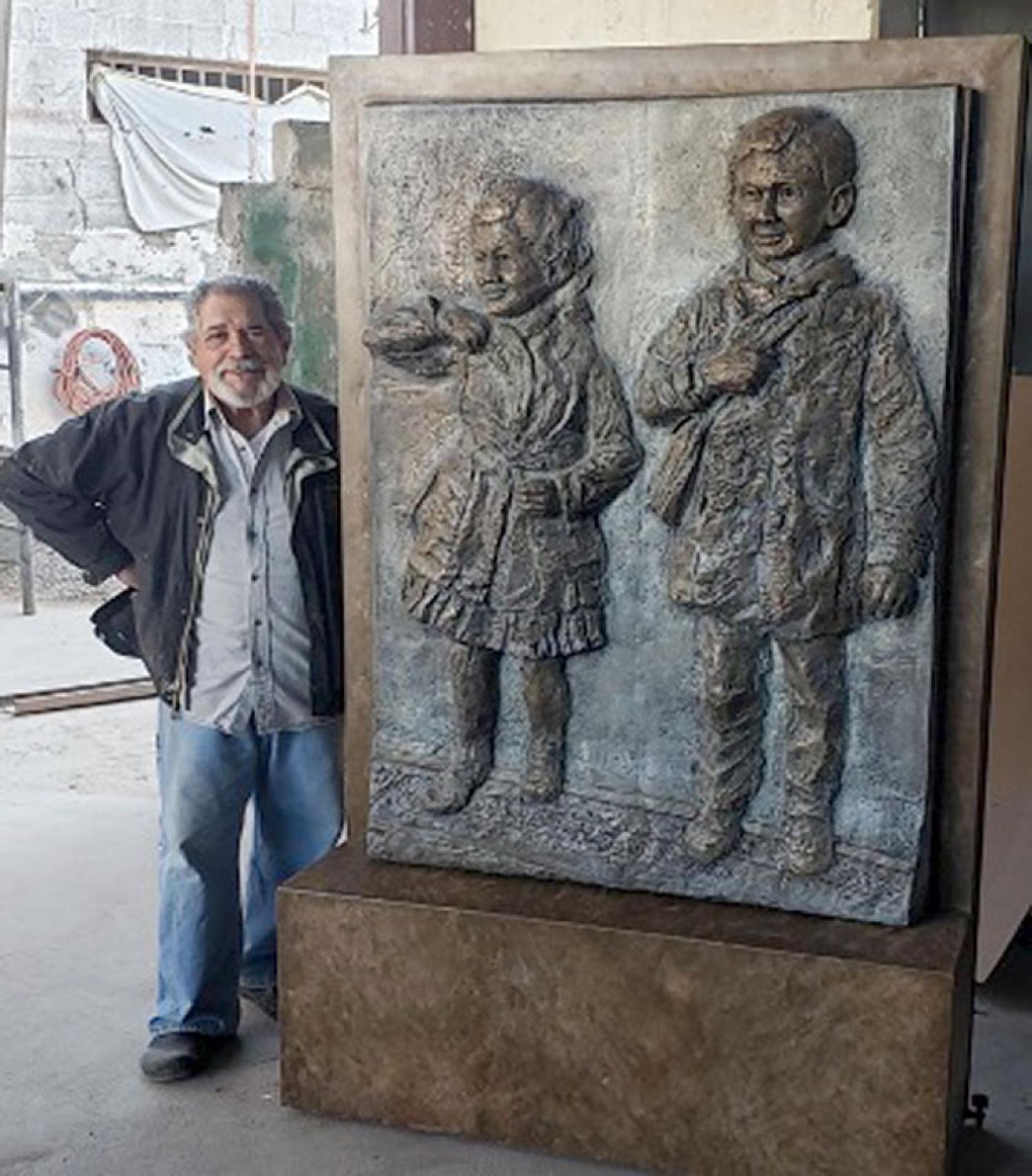 Artist Reynaldo Rivera with sculpture to memorialize the case at the Alamosa County Courthouse.