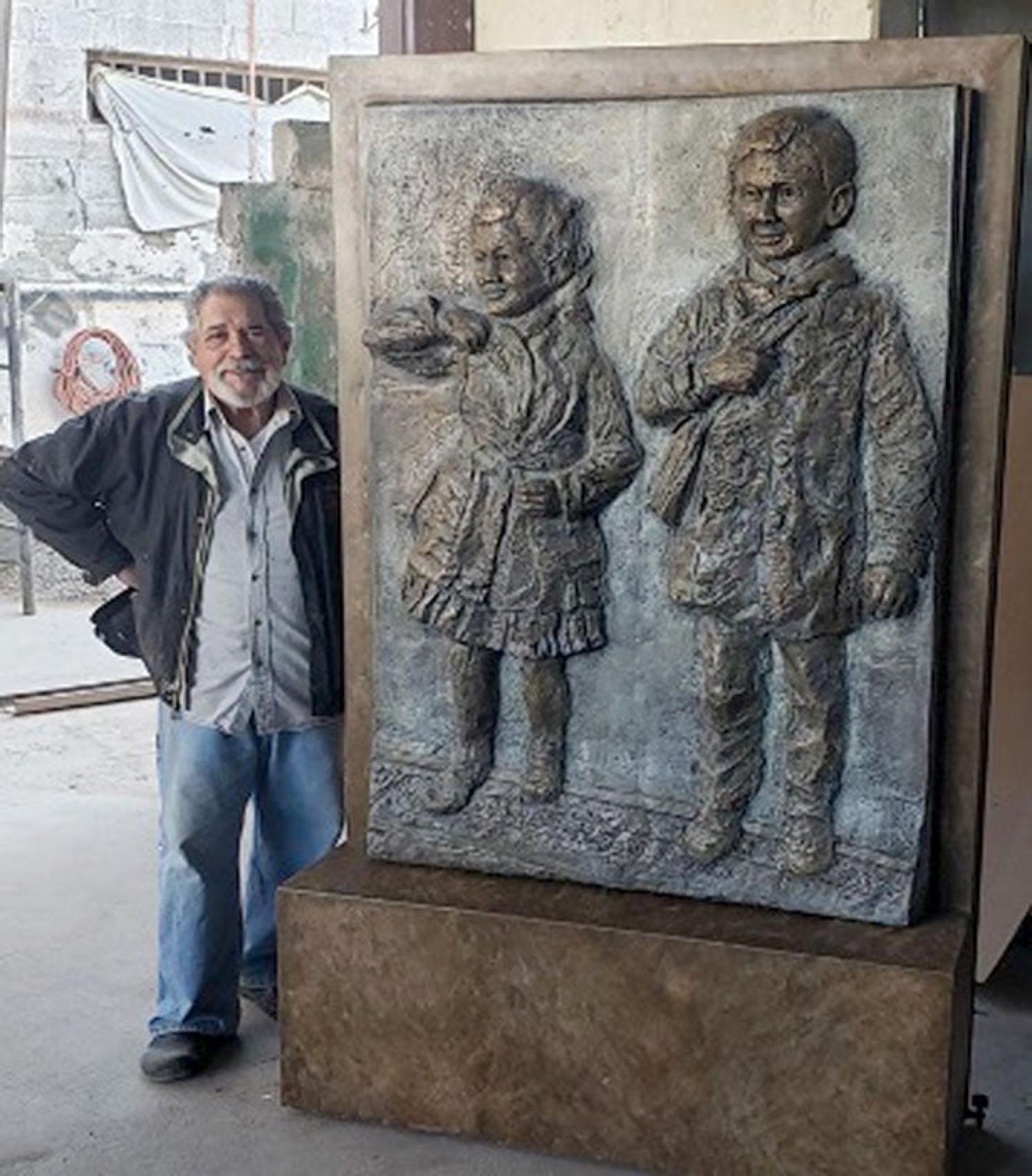 A rtist Reynaldo Rivera with a sculpture to memorialize the case at the Alamosa County Courthouse