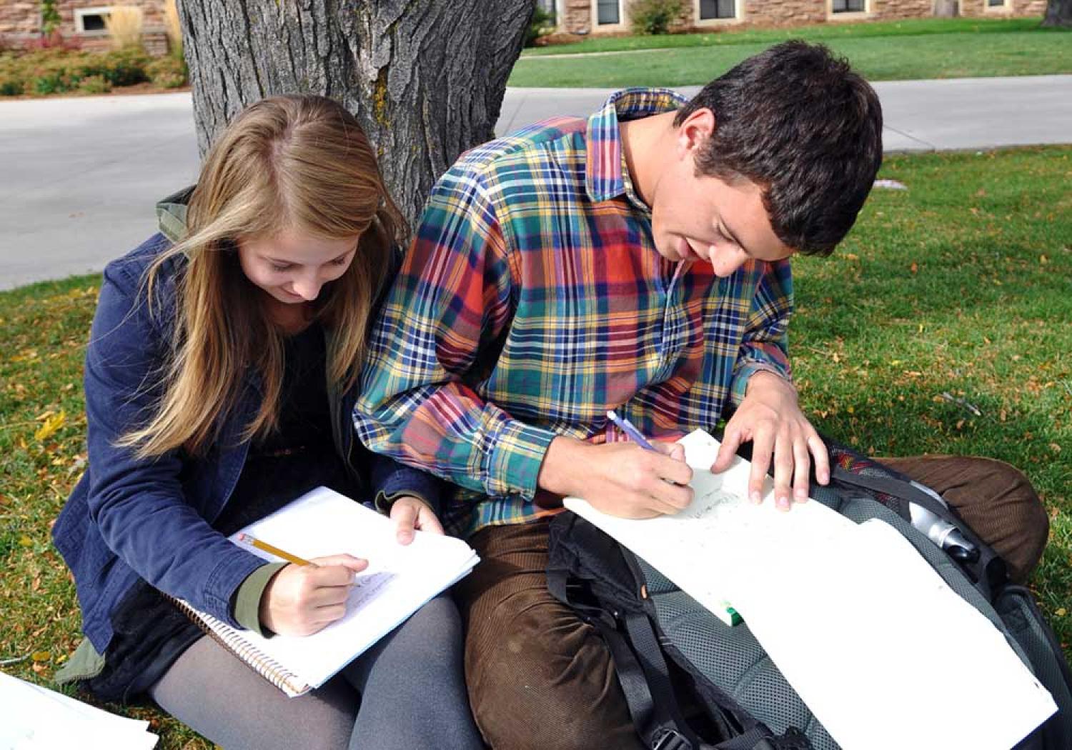 Students writing outdoors