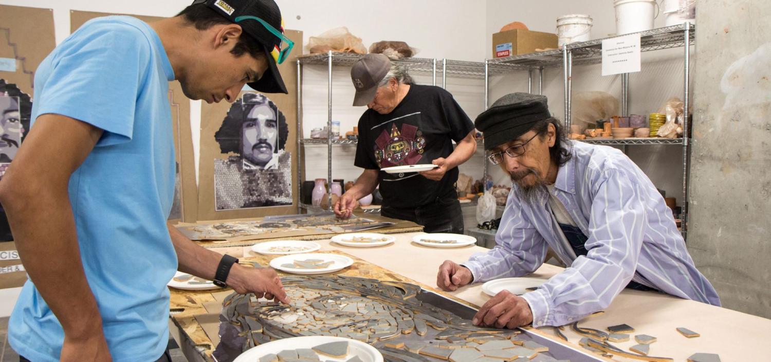 Community members piece together a mosaic of Neva Romero, one of Los Seis, now memorialized in sculptures on CU Boulder's campus.