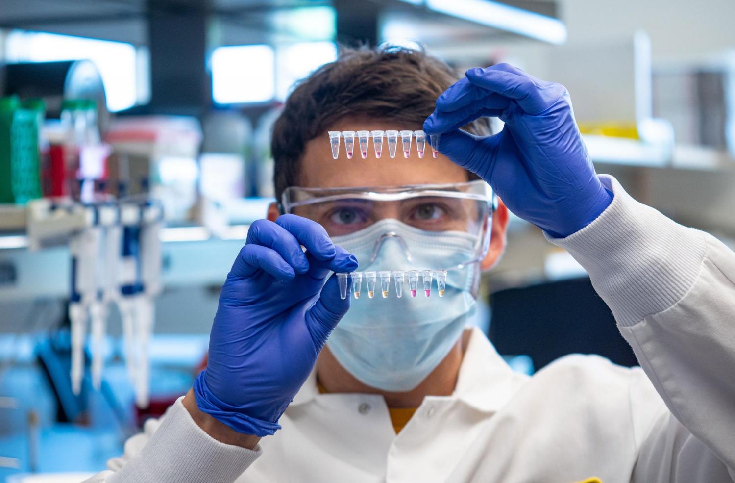 Researcher with COVID-19 test results