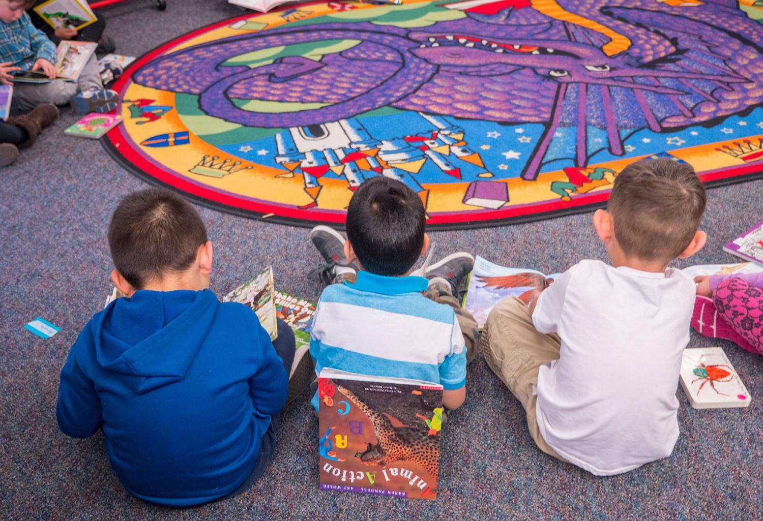 Kindergarten students with books in class