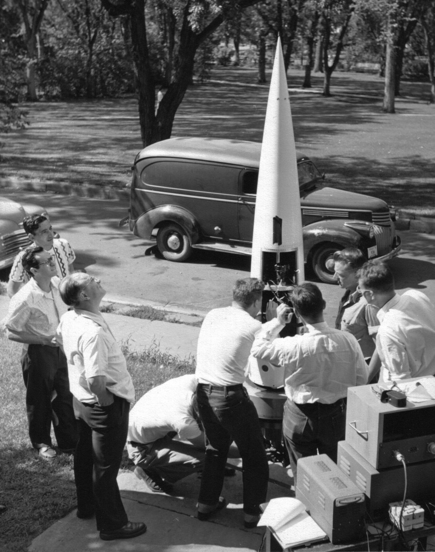 Scientists and engineers assemble a sounding rocket on the CU Boulder campus circa 1948