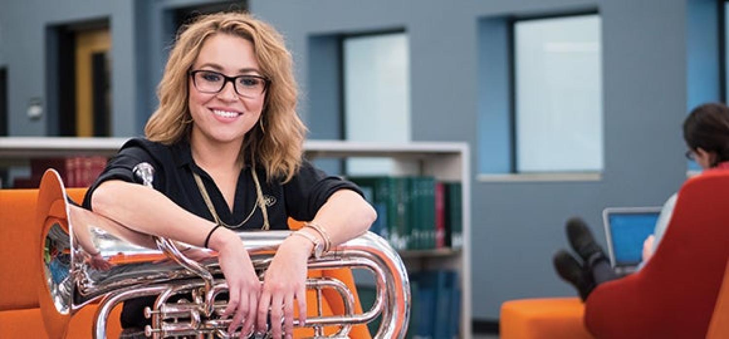 Student holding their horn instrument