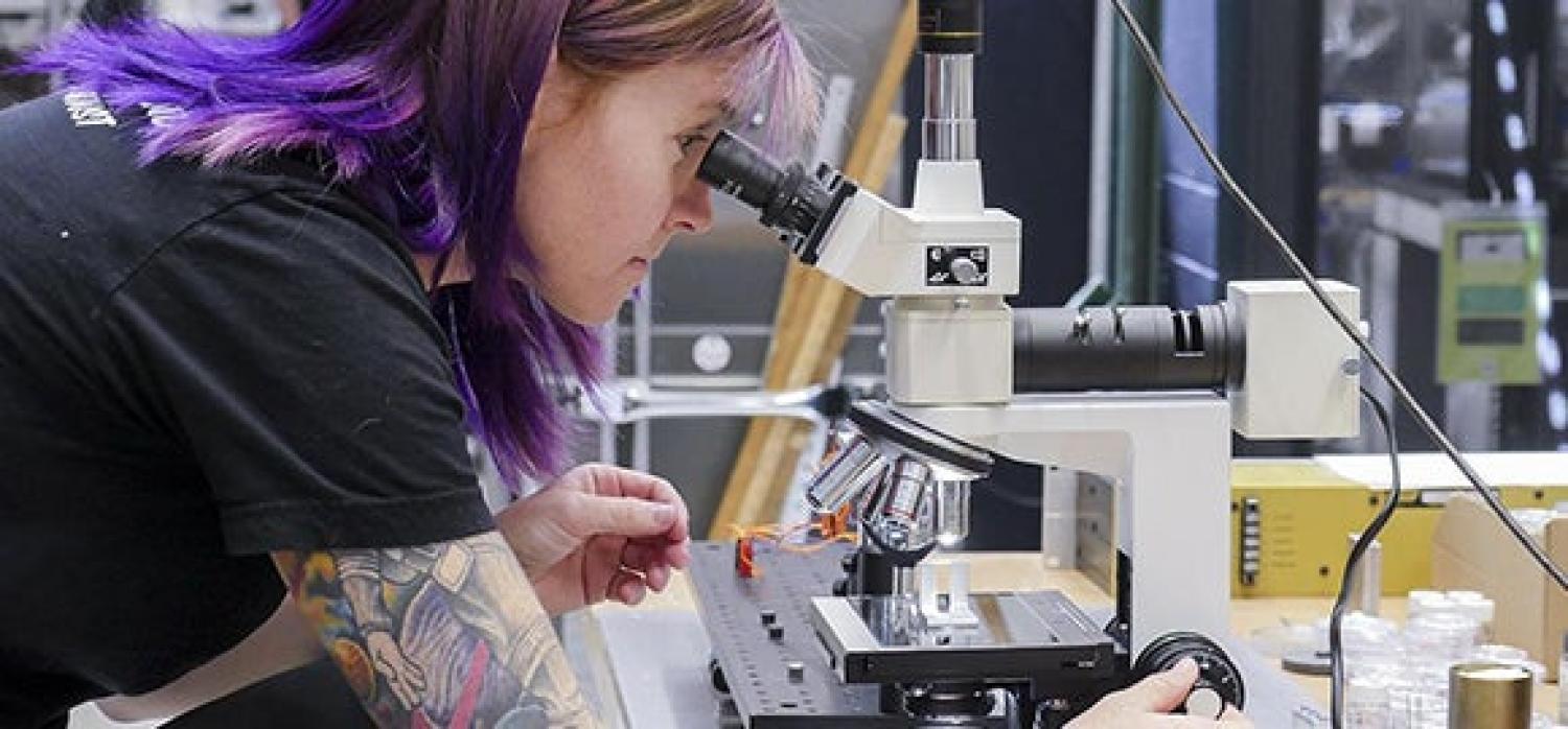 Student looking into microscope