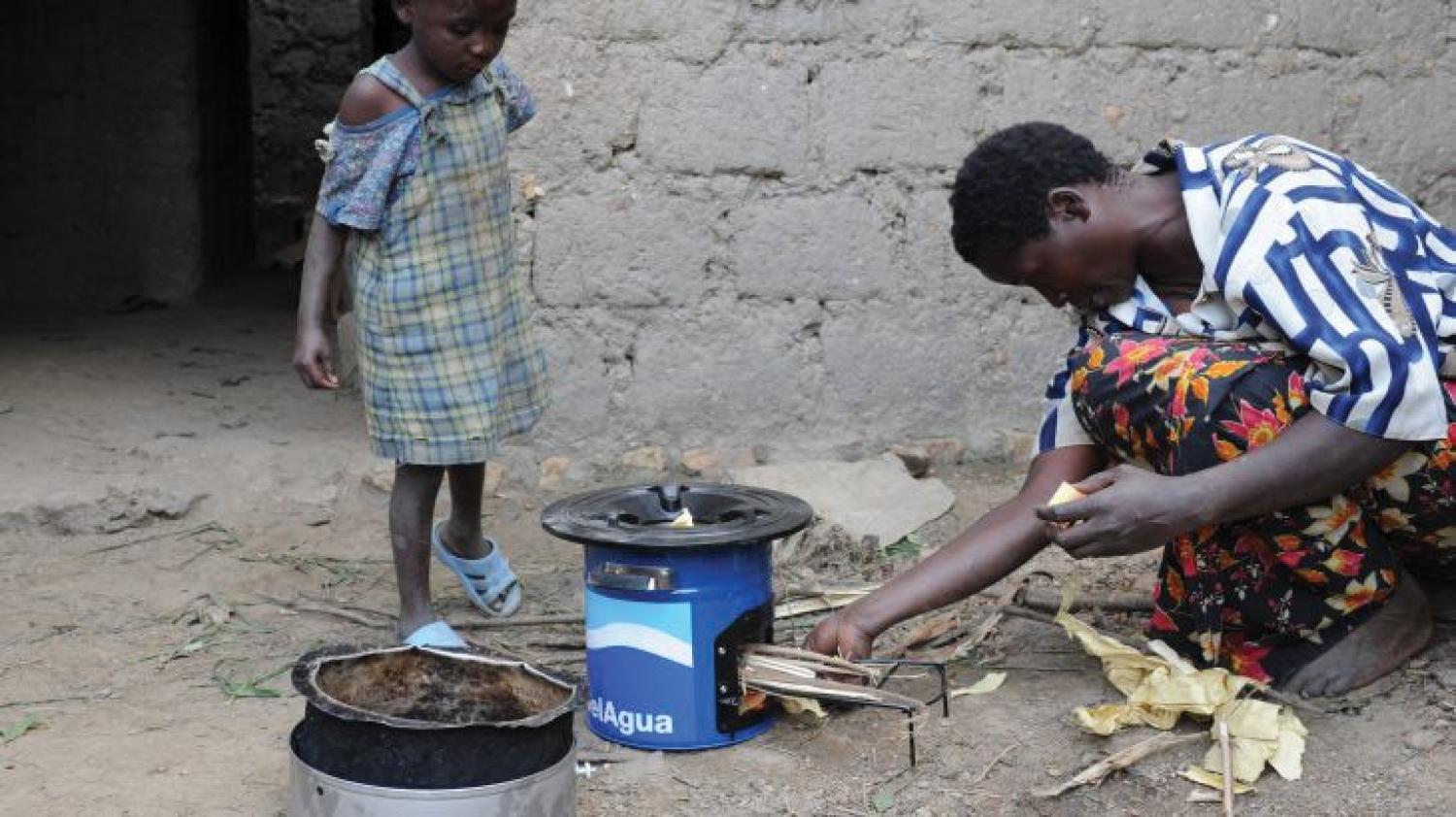 Rwandan family with biomass-burning cookstove