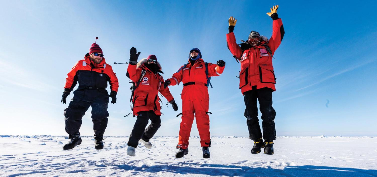 CU Boulder researchers jumping in the air in the arctic