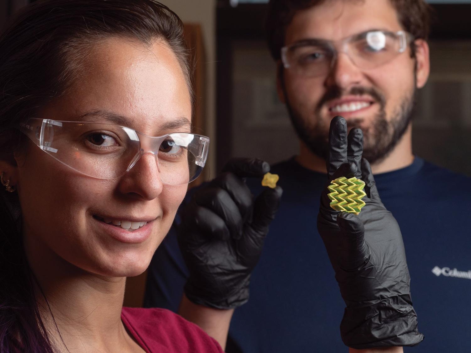 Researchers holding shape shifting material