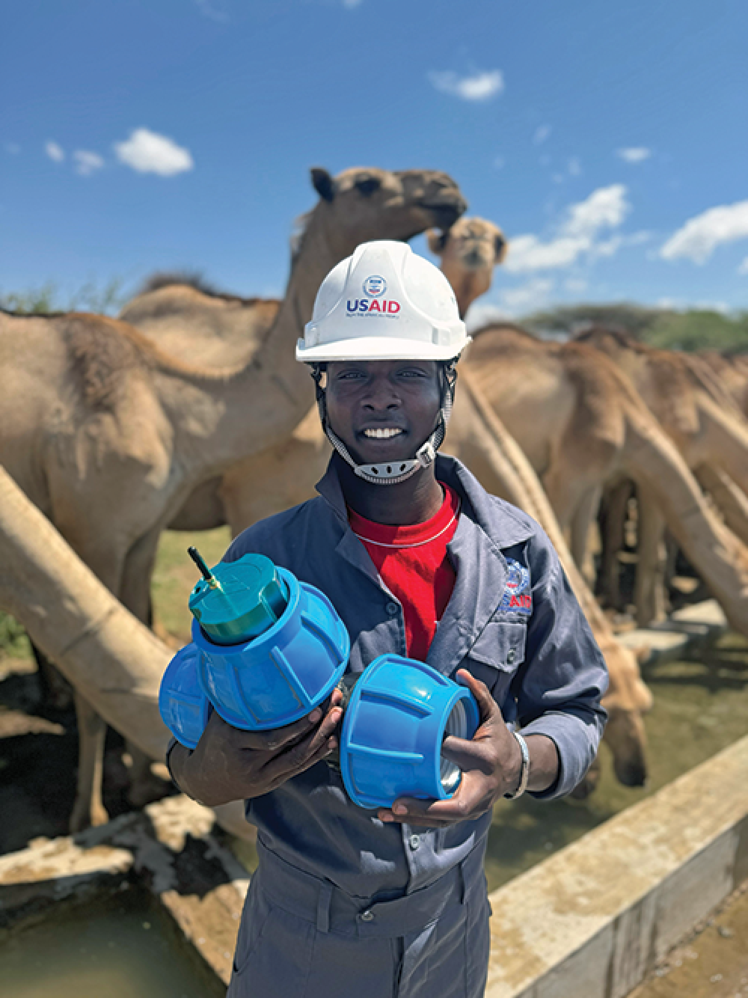 A team member holds a water quality sensor used to test for water contamination