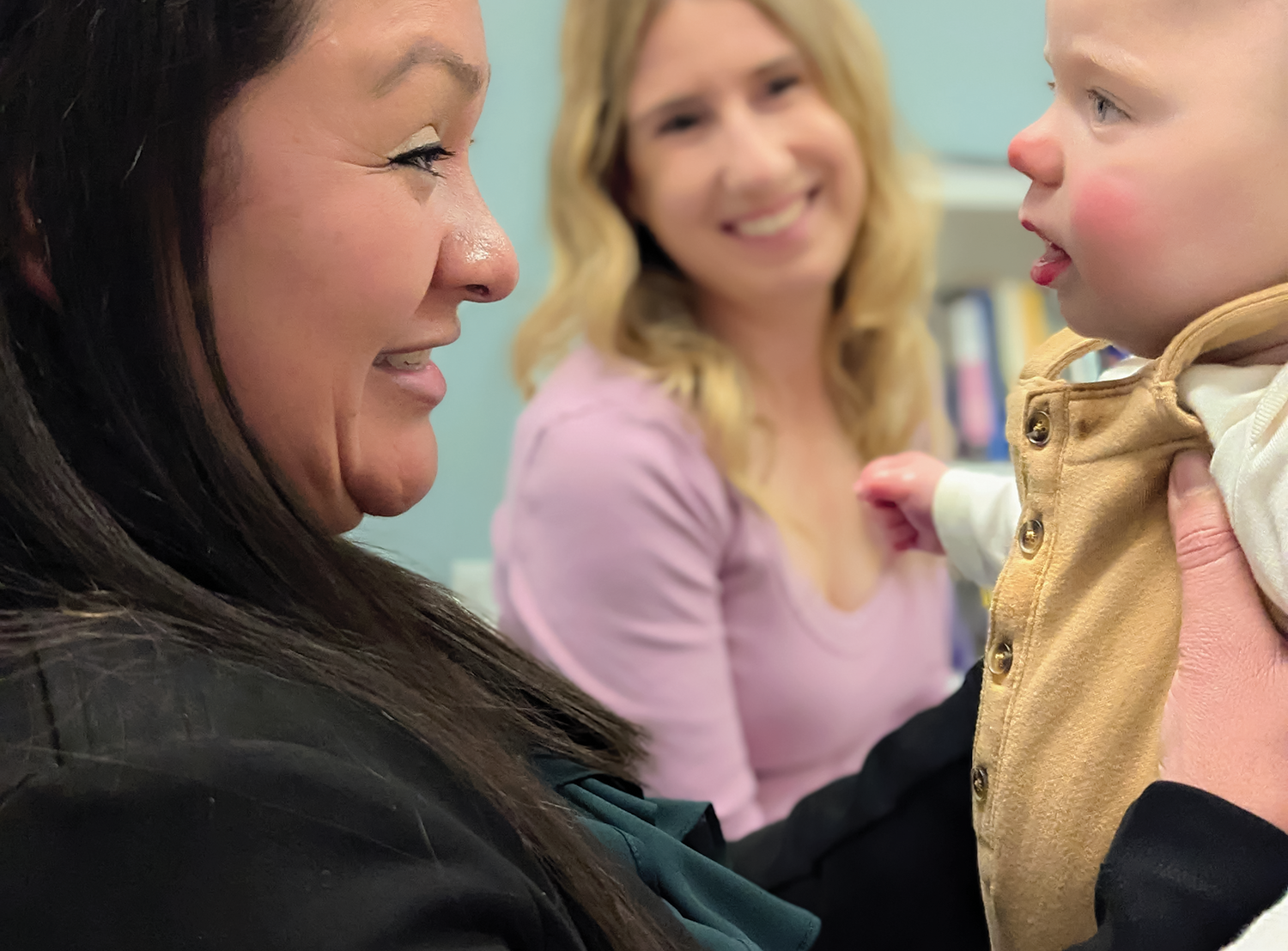 Alma program peer mentors Gracia Deras, left, and Shannon Beckner sit with baby Wyatt