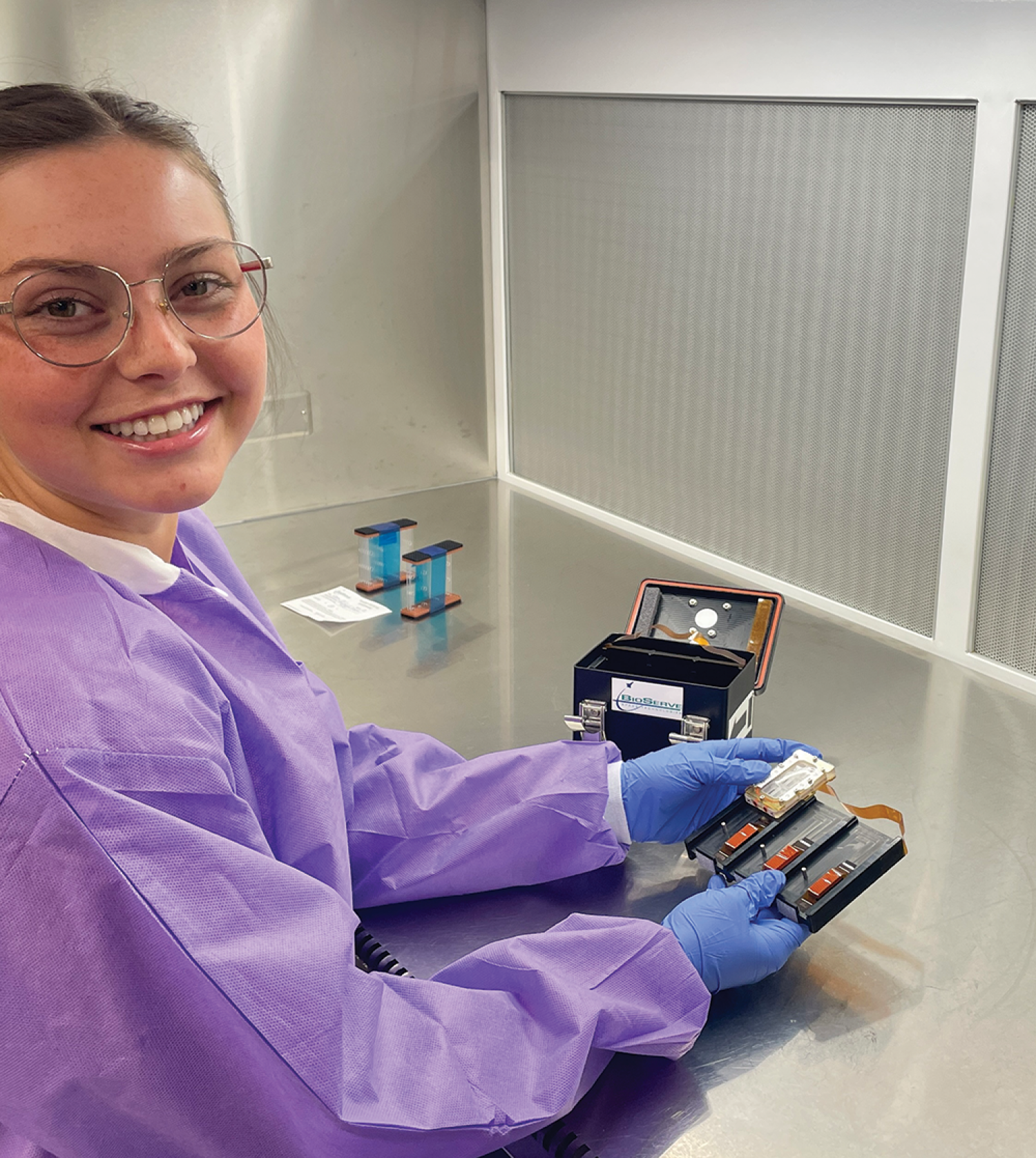 Adeline Loesch assembles space “petri dishes” containing biological organisms in a lab on the CU Boulder campus.
