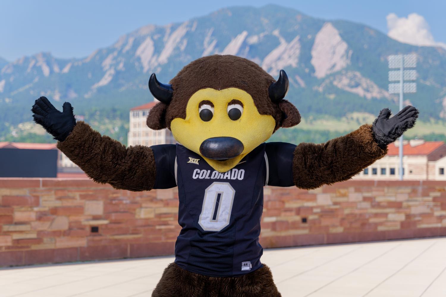 mascot Chip in front of the flatirons