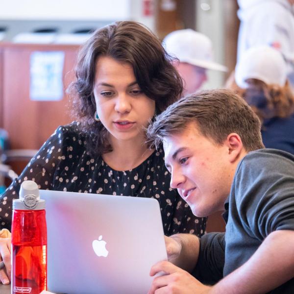 Students looking at laptop