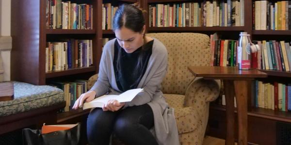 Student reading book in library