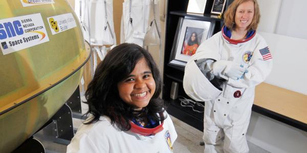 Two aerospace engineer students in astronaut suits