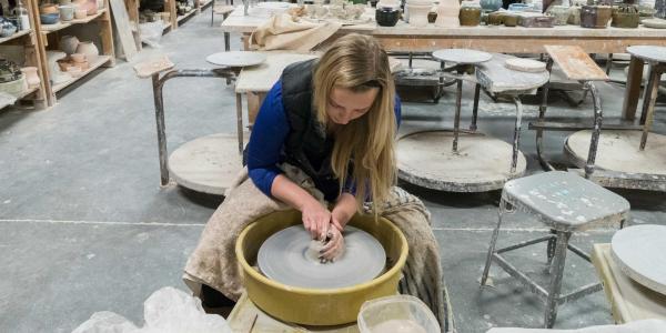 Student in wheel throwing class