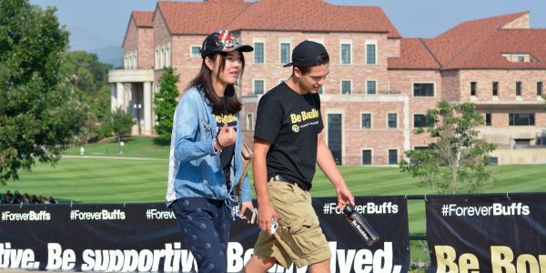 Students walking by Koelbel building