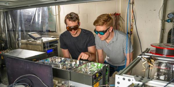 Two students working at a laser table