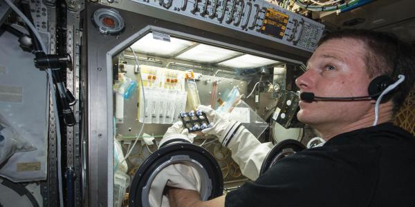 NASA astronaut Terry Virts manipulating a BioServe experiment on ISS. 