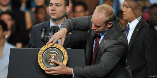 Man next to podium with American plaque