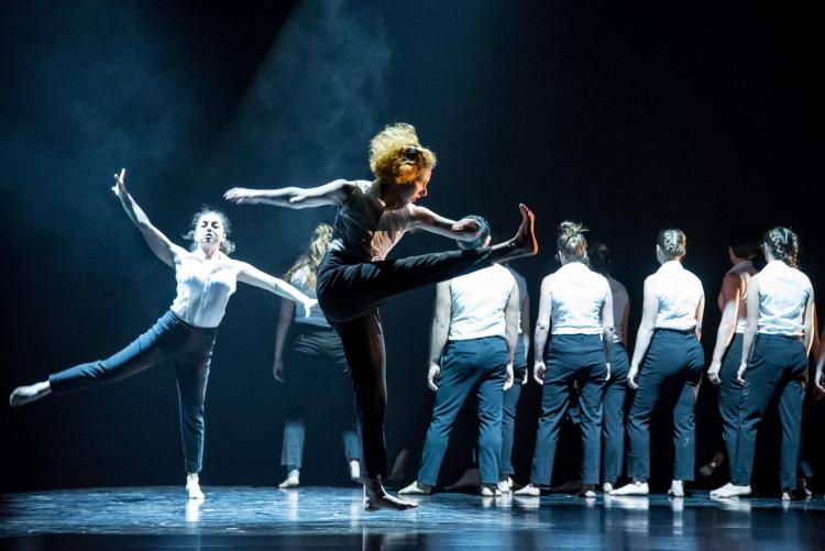 Performers dancing on stage at University Theatre