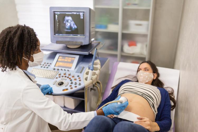 Doctor performing a sonogram on a patient