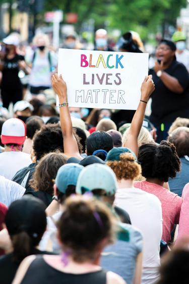 Black Lives Matter sign held up at gathering