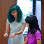 Teacher and student looking at fossil kit