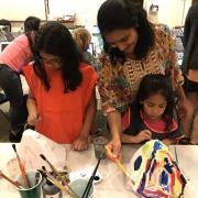 Workshop with students painting lanterns.