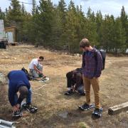 Researchers put snowshoes on in the forest