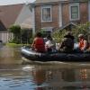 A Marine, a member of the Texas Highway Patrol and Texas State Guard escort a couple to higher ground, Houston, Texas, Aug. 31, 2017.