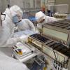 Graduate students and LASP engineer Nicholas DeCicco install CUTE into LANDSAT-9