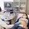 Doctor performing a sonogram on a patient