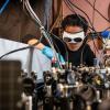 Qizhong Liang, a PhD candidate in JILA and the Department of Physics, demonstrates how the laser-based breathalyzer works, in the Ye lab at JILA.