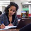 Student working on an assignment in the library