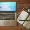 Laptop and notebook on desk